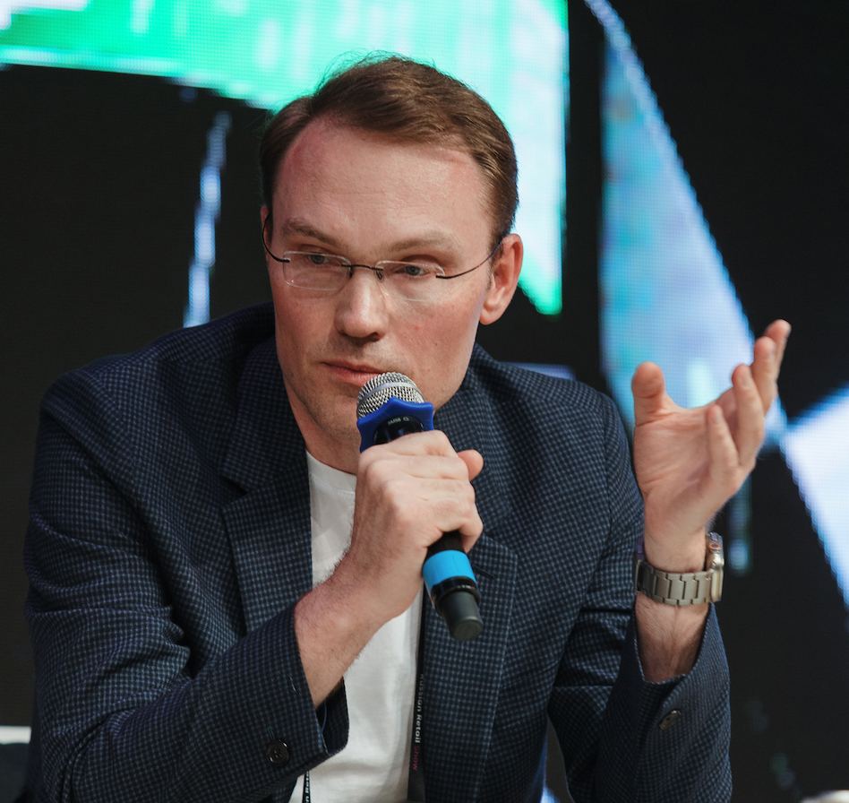 Vadim Vasilyev speaking with a microphone at a conference